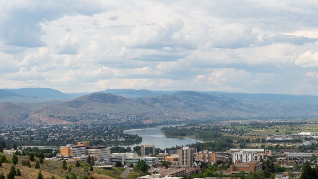 Aerial view of Kamloops with the river winding past the city and surrounding hills